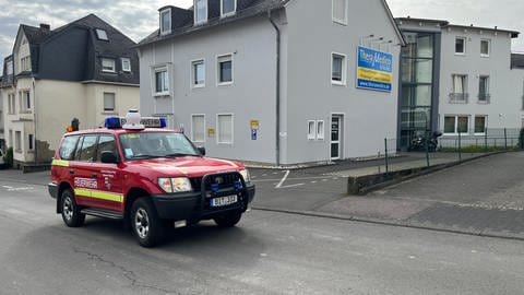 Ein Feuerwehrauto fährt durch geäumte Straßen in Bitburg.