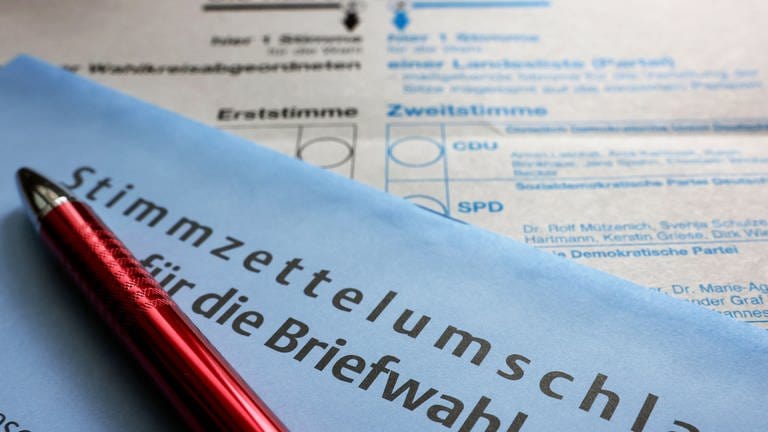Bundestagswahl 2021: Ein Stimmzettel und ein Umschlag für die Briefwahl liegen auf einem Tisch.
